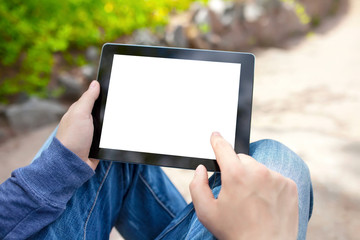 man sitting in the park and holding tablet with isolated screen