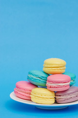Sweet and colourful french macaroons on retro-vintage background