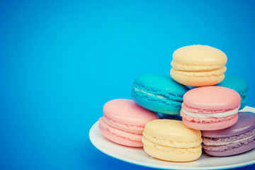 Sweet and colourful french macaroons on retro-vintage background