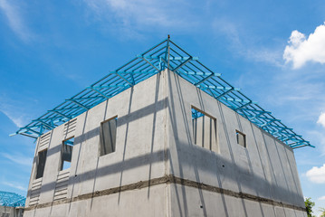 New home under construction using steel frames against cloudy sk