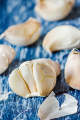 Organic garlic cloves on the wooden background