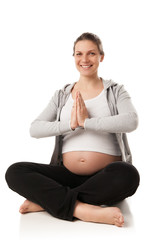 Pregnant woman relax doing yoga over white