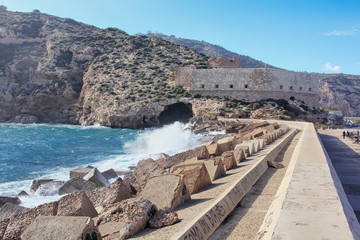 Large waves crashing and splashing on a seawall