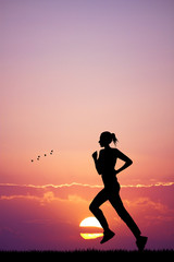 Girl running at sunset