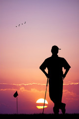 man playing golf at sunset