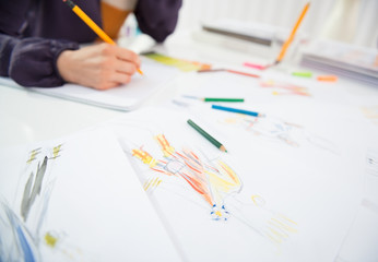 Closeup on fashion designer making sketches