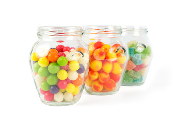 Glass jars filled with different colorful candies