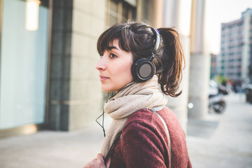 young beautiful hipster woman listening music
