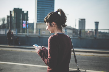 young beautiful hipster woman using smart phone