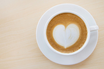 Hot coffee with heart pattern in white cup