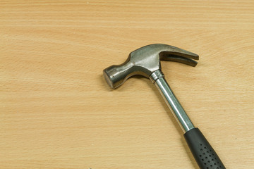 Iron hammer on wooden table