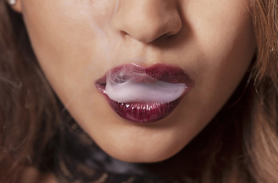 Sexy woman smoking closeup