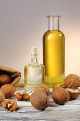 Walnut oil and nuts on wooden table