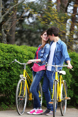 Fototapeta na wymiar Young couple with bicycles in park