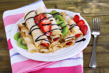 Delicious pancakes with strawberries and chocolate