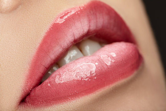 Beautiful female with pink shiny lips close up