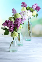 Beautiful spring flowers in glass bottles,