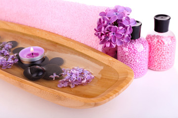 Composition with spa treatment, wooden bowl with water, towel