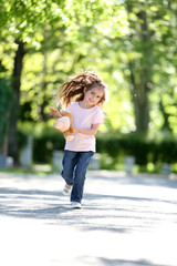 Happy little girl in the green park