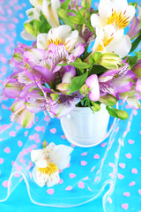 Bouquet of freesias in pail on table close-up