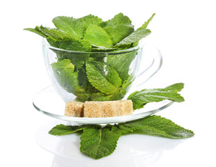 Mint leaves in glass cup isolated on white