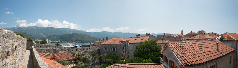 Fototapeta premium Budva bay behind the tile roofs of old town, Montenegro.
