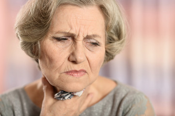 Elderly woman having soar throat