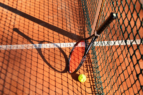tennis ball and racket are near the net horizontal 0193
