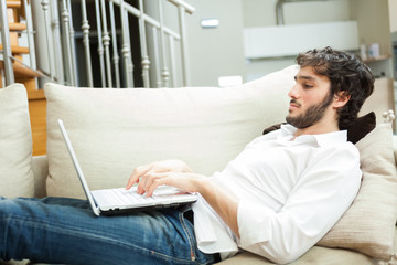 Man using a laptop in his apartment