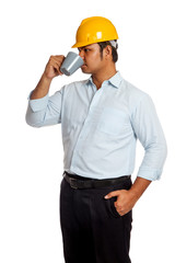 Asian engineer man drinking a cup of coffee