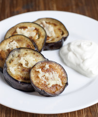 Fried eggplant with garlic and sour cream on a   plate.