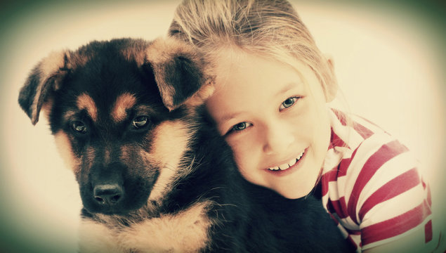 Child Hugging A Puppy