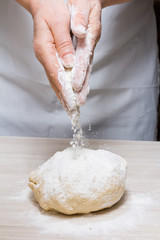 Hands kneading a dough