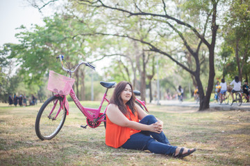 Naklejka na ściany i meble Happy woman posing with bicycle