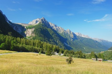 Fototapeta na wymiar Maloja Pass, view of the valley and the dam on rock, Swiss Alps