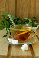 Cup of tea with lemon and mint.