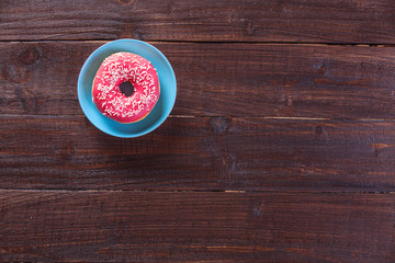 Donut on wooden table.