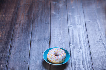 Donut on wooden table.