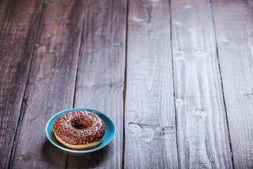 Donut on wooden table.