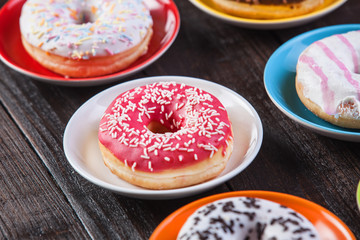Donuts on wooden table.