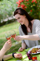 Fototapeta premium cheerful young women cheering with friend at barbecue party