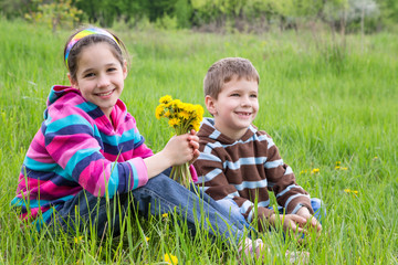 Two kids with dandelions