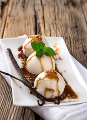 Ice cream scoops on wooden table.