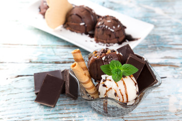 Ice cream scoops on wooden table.