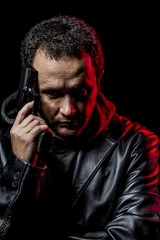 Private detective with leather jacket and gun, pointing