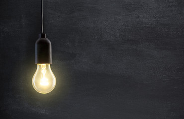 Light bulb lamp on blackboard background with copy space - Powered by Adobe
