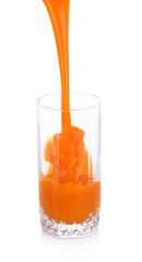 Juice pouring into glass isolated on white