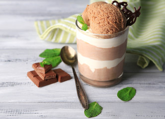 Tasty chocolate mousse with sorbet on wooden table