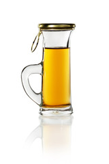 A small shot glass of delicious liquor with reflection