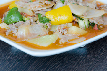 Spicy pork salad with vegetable on wood table